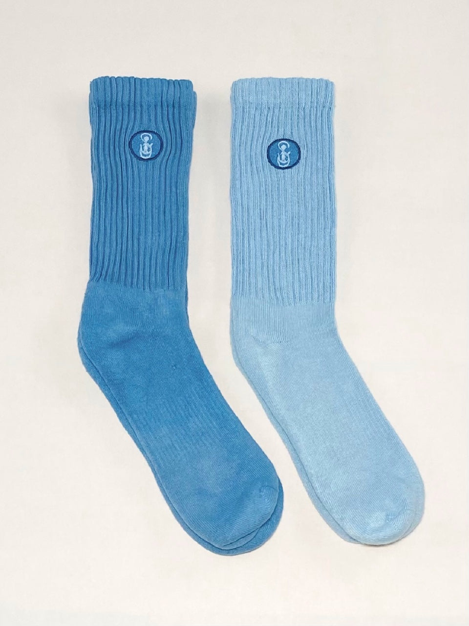 Two blue and light blue crew socks.