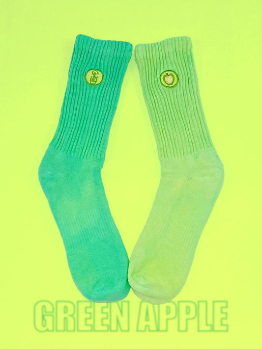 One pair of mismatch green hand dyed crew socks.